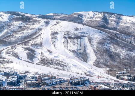 Park City Utah mountain with ski trails and buildings on a snowy scene in winter Stock Photo