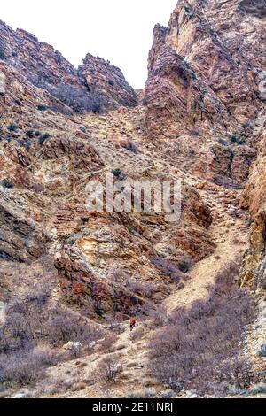 Massive rocky mountain in Provo Canyon Utah with hikers on a trail to the peak Stock Photo