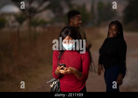 an african lady using her cellphone to chat Stock Photo