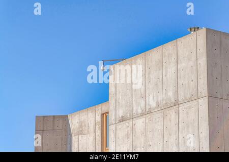 School building with dome security camera against clear blue sky on a sunny day Stock Photo