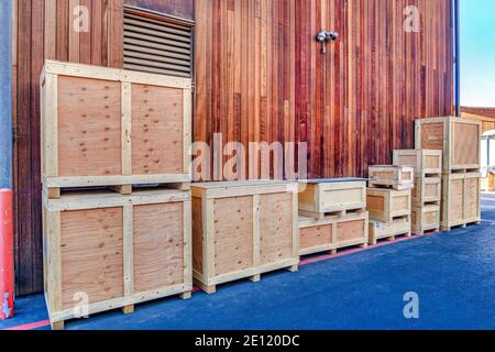 Crate container boxes against exterior wall and ventilator window of building Stock Photo