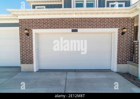 Wide Garage Door Of Residential House And Concrete Driveway In Front Stock Photo Alamy