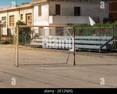 Rusty Football Goal Stands On A Concrete Playing Field, Sardinia, Italy Stock Photo