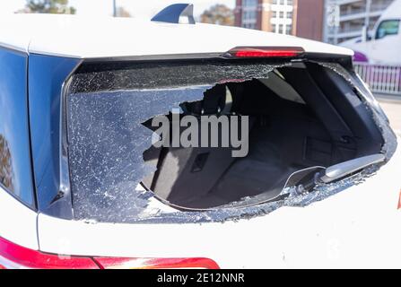 Shattered glass on rear of vehicle after a crime Stock Photo