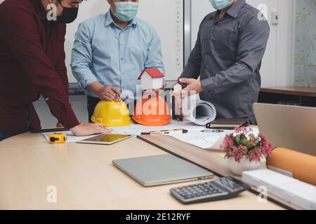 Engineer and Architect concept, Engineer Architects  and Interior designer working with blueprints Stock Photo