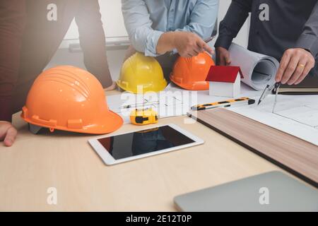 Engineer and Architect concept, Engineer Architects  and Interior designer working with blueprints Stock Photo