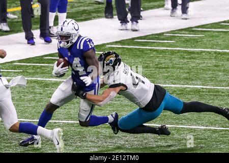 Indianapolis, Indiana, USA. 3rd Jan, 2021. Indianapolis Colts wide receiver Zach Pascal (14) is tackled by Jacksonville Jaguars linebacker Joe Schobert (47) in the game between the Jacksonville Jaguars and the Indianapolis Colts at Lucas Oil Stadium, Indianapolis, Indiana. Credit: Scott Stuart/ZUMA Wire/Alamy Live News Stock Photo