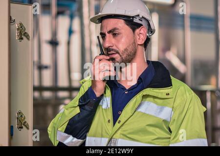 Engineers are using radio communication To coordinate with the team in the production process of the factory Stock Photo