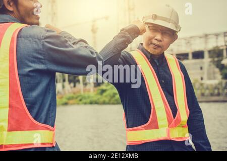 Two people new normal Hello do not Shake hand Social distancing, Engineer shake hand no touch prevent Corona virus Stock Photo
