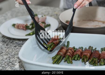 Prepare Bacon In Frying Pan And Turn With Spatula Stock Photo