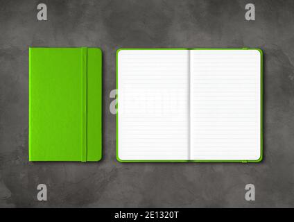 Green closed and open lined notebooks mockup isolated on dark concrete background Stock Photo