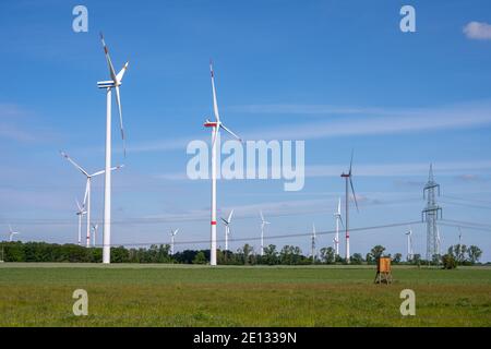 Modern windmills and a power line in Germany Stock Photo