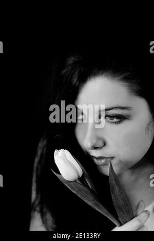 teenager with tulip in hand and romantic look II Stock Photo