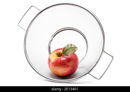 ripe red apples in a colander on a white background Stock Photo