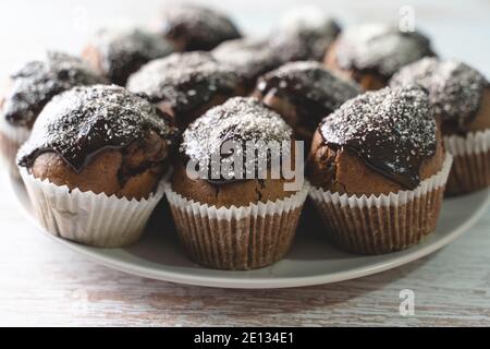 Close up on chocolate muffin cakes in a plate on table Stock Photo