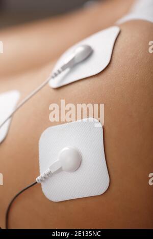 Electrode Stimulating massage of the buttocks and legs at home. Medical procedure for muscle tone and beauty Stock Photo