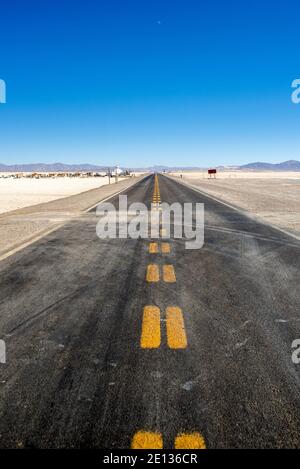 Straight road passing in the middle of Salinas Grandes, Argentina at the border with Chile, one of the biggest salt lakes in the world Stock Photo