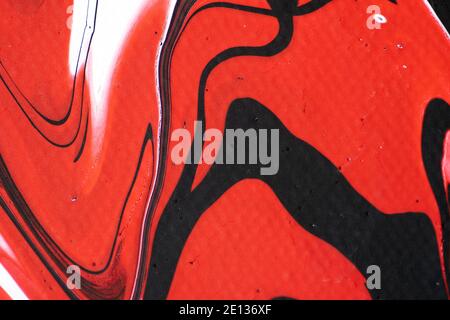 Marbled acrylic colored pattern in the colors red, black, white and pink Stock Photo