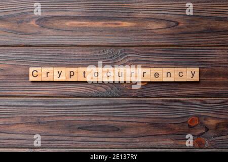 Cryptocurrency word written on wood block. Cryptocurrency text on cement table for your desing, concept. Stock Photo
