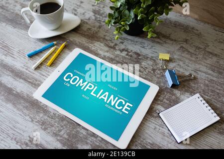 Compliance concept with icons and diagrams. Regulations, law, standards, requirements, audit. Concept on device screen