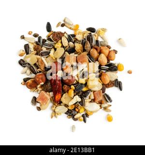 Isolated heap of parrot fodder of dried fruits, nuts and seed mix. Healthy food for pets. Top view Stock Photo