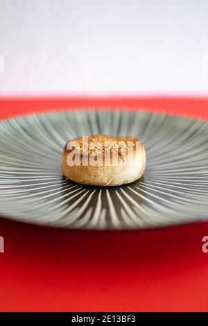 a single traditional Spanish Christmas sweet called a Mantecado on a plate Stock Photo