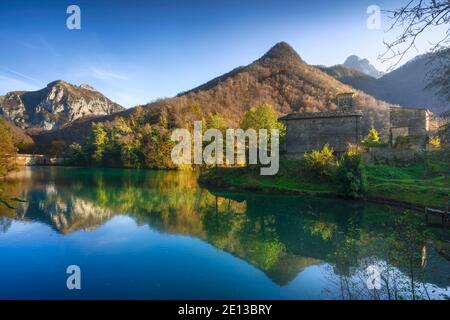 Isola Santa medieval village, lake and Alpi Apuane mountains in autumn foliage. Garfagnana, Tuscany, Italy Europe. Stock Photo