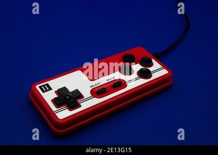 Retro gamepad controller on blue background Stock Photo