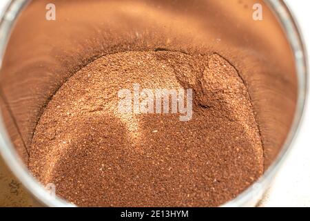 Scattered ground brown coffee in a metal jar ground coffee beans Stock Photo