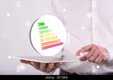 Energy efficiency concept above a tablet held by a man in background Stock Photo
