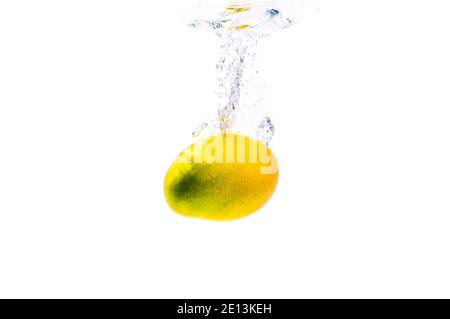 Mango sinking in water isolated on white Stock Photo