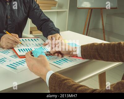 Teamwork. Two managers discuss the annual business plan and financial strategy. Stock Photo