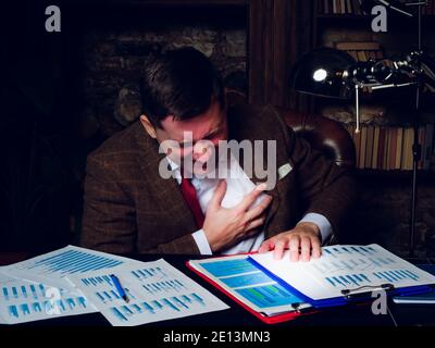 Heart disease, heart attack due to stress. The man holds on to his chest. Stock Photo