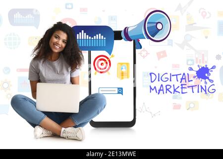 Collage of young African-American woman with laptop and mobile phone on white background. Concept of digital marketing Stock Photo