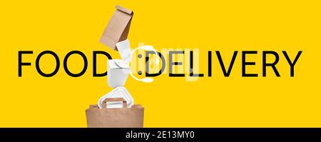 Paper bag with falling containers and text FOOD DELIVERY on color background Stock Photo