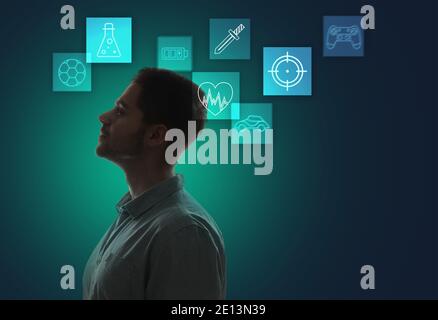 Young man with video games icons on dark color background Stock Photo