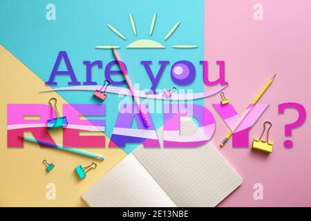 Text "Are you ready?" and set of school supplies on color background Stock Photo