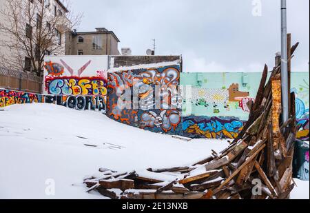 Colourful graffiti spray painted on walls in a run-down area of downtown Reykjavik, capital city of Iceland with a covering of snow in winter Stock Photo