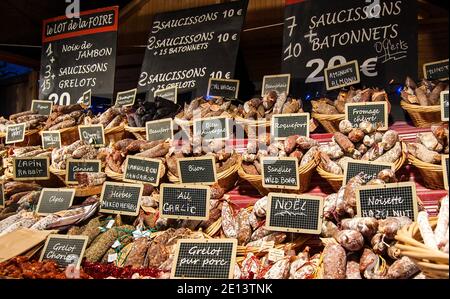 Sausage assortment at butcher stall at food market. Christmas market in Paris, France. Stock Photo