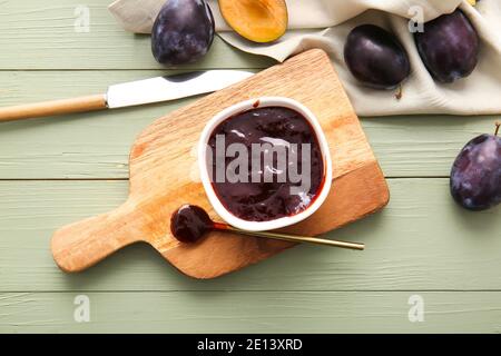 Bowl with delicious homemade plum jam on wooden background Stock Photo