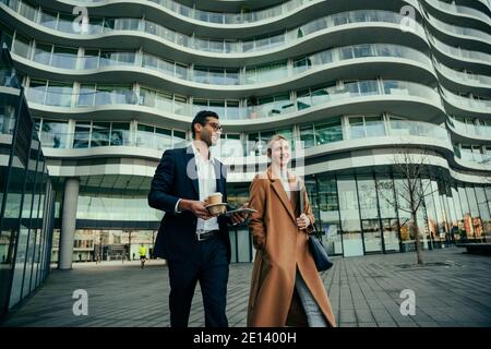 Business colleagues walking together to work discussing new collaboration project  Stock Photo