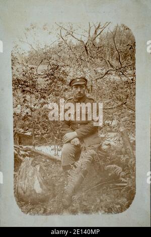 RUSSIA / Latvia - CIRCA 1916-1917: An antique photo shows Latvian soldier during World War One battlefield posing in front of a camera Stock Photo