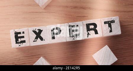 text of EXPERT on wood abc cubes at wooden background. Stock Photo