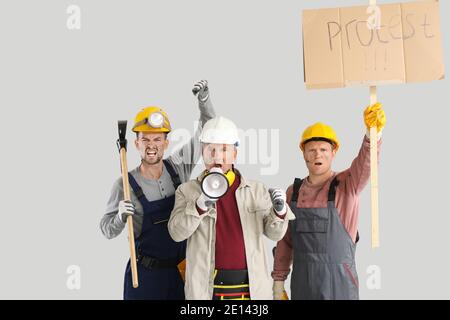 Protesting miner men on grey background Stock Photo
