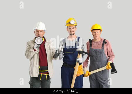 Protesting miner men on grey background Stock Photo