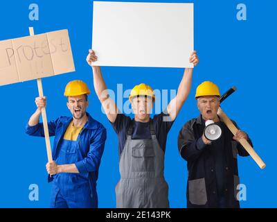 Protesting miner men with placards on color background Stock Photo