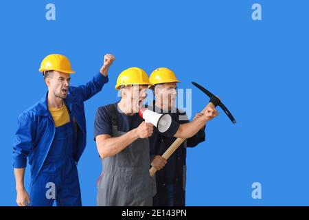Protesting miner men on color background Stock Photo