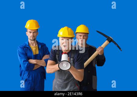 Protesting miner men on color background Stock Photo