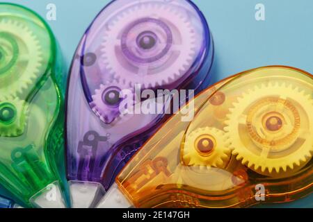 Stationery correction tapes are Multicolored on a blue background. Free space. The view from the top. Blue, green, yellow, lilac Stock Photo