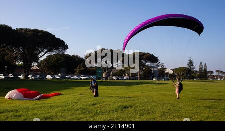 Rondebosch Common-  Cape Town, South Africa - 23/10/2020 Two male paragliders, preparing their equipment and testing the wind before taking off. Stock Photo